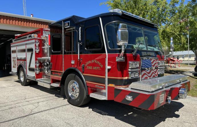 image for black over red fire engine that says high springs fire department 